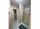 Bathroom featuring walk-in shower with glass doors and white tiled floors at 5363 Forest Dr, Loganville, GA 30052