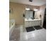 Bathroom featuring a dual sink vanity, soaking tub and updated mirrors and lighting at 5363 Forest Dr, Loganville, GA 30052