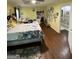 Spacious bedroom featuring hardwood floors and a desk with access to the staircase at 5363 Forest Dr, Loganville, GA 30052