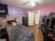 Cozy bedroom with hardwood floors, a comfortable bed, and access to an additional room at 5363 Forest Dr, Loganville, GA 30052