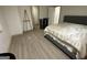 Bedroom boasts a comfortable bed with a neutral palette and ample natural light at 5363 Forest Dr, Loganville, GA 30052