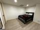 Neutral bedroom featuring a bed, blank walls and light-colored floors at 5363 Forest Dr, Loganville, GA 30052