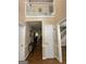 A foyer with wood floors, white trim, doors and staircase at 5363 Forest Dr, Loganville, GA 30052