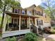 Inviting front porch with seating area of charming two-story home featuring a front porch, attached garage at 5363 Forest Dr, Loganville, GA 30052