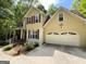 Close up of the house showing the garage, flower garden and a charming two-story home at 5363 Forest Dr, Loganville, GA 30052
