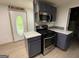 The renovated kitchen showcases a modern range and ample counter space at 5363 Forest Dr, Loganville, GA 30052