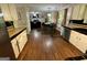 Spacious kitchen featuring wood floors, black countertops, and modern appliances at 5363 Forest Dr, Loganville, GA 30052