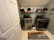 Convenient laundry room with modern washer and dryer units and shelf storage at 5363 Forest Dr, Loganville, GA 30052