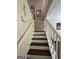 Staircase with white railings and wood steps leading upstairs at 5363 Forest Dr, Loganville, GA 30052