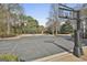 Community basketball court with a basketball hoop with a clear backboard surrounded by trees at 100 Trotters Rdg, Fayetteville, GA 30215