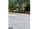 Community concrete basketball court surrounded by a wooded area, with a basketball hoop at 100 Trotters Rdg, Fayetteville, GA 30215