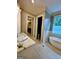Bright bathroom with a standalone soaking tub, double vanity, and access to a walk-in closet at 100 Trotters Rdg, Fayetteville, GA 30215