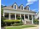 Charming traditional home featuring a welcoming front porch, well-manicured lawn, and classic architectural details at 100 Trotters Rdg, Fayetteville, GA 30215