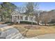 Cottage style exterior with a front porch, shutters, and landscaping within a well-maintained community at 100 Trotters Rdg, Fayetteville, GA 30215