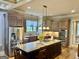 Spacious kitchen featuring custom cabinets, stainless appliances, and a center island with granite countertop at 100 Trotters Rdg, Fayetteville, GA 30215