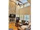 Open concept living room with stone fireplace, vaulted ceiling, and hardwood floors at 100 Trotters Rdg, Fayetteville, GA 30215