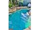 Clear blue swimming pool with stone accents and a surrounding patio area at 100 Trotters Rdg, Fayetteville, GA 30215