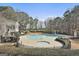Community pool featuring a lap area, hot tub, sun bathing chairs, adjacent to wooded area, and covered seating area at 100 Trotters Rdg, Fayetteville, GA 30215