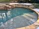 Backyard pool featuring a stone retaining wall, a small waterfall, and a tanning shelf at 100 Trotters Rdg, Fayetteville, GA 30215