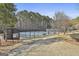 Community tennis court ready for play with adjacent benches, walking path, and tree buffer at 100 Trotters Rdg, Fayetteville, GA 30215