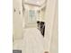 Well-organized walk-in closet with custom shelving, hanging rods, and natural lighting at 100 Trotters Rdg, Fayetteville, GA 30215