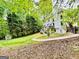 Serene backyard with a winding walkway, shed, and lush greenery at 2870 Willow Wisp Way, Cumming, GA 30040