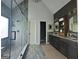 Modern bathroom with dual vanity, dark wood cabinets, decorative mirrors, and luxurious glass shower at 2870 Willow Wisp Way, Cumming, GA 30040