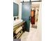 Bathroom with sliding barn door with access to bathtub and shower with floral curtain at 2870 Willow Wisp Way, Cumming, GA 30040