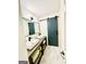 This bathroom has a sliding barn door and a double sink vanity. The floors are tiled at 2870 Willow Wisp Way, Cumming, GA 30040