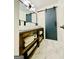 Bathroom vanity with double sinks, wood base, white countertop, and modern sliding door at 2870 Willow Wisp Way, Cumming, GA 30040