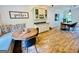 Open-concept dining area with wood-look tile, a modern table, and a breakfast nook with a banquette at 2870 Willow Wisp Way, Cumming, GA 30040