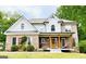 Lovely brick home with white gables, a welcoming porch, and manicured landscaping at 2870 Willow Wisp Way, Cumming, GA 30040