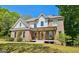 Inviting two-story brick home with a charming front porch and lush green lawn at 2870 Willow Wisp Way, Cumming, GA 30040