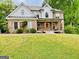 Attractive brick and white home with a covered porch and well-maintained lawn at 2870 Willow Wisp Way, Cumming, GA 30040
