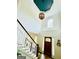 Grand foyer with soaring ceilings, a decorative chandelier, and a dark wooden front door at 2870 Willow Wisp Way, Cumming, GA 30040