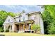 Charming brick two-story home with a welcoming front porch and lush landscaping at 2870 Willow Wisp Way, Cumming, GA 30040