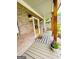 Inviting front porch with wood columns, swing, and seasonal decorations at 2870 Willow Wisp Way, Cumming, GA 30040