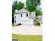 Exterior view highlighting the attached garage and concrete driveway, showcasing ample parking space at 2870 Willow Wisp Way, Cumming, GA 30040