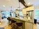 Modern kitchen with stainless steel appliances, bar stool seating, and views into the living room at 2870 Willow Wisp Way, Cumming, GA 30040