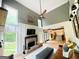 Stylish living room featuring a brick fireplace, soaring ceilings, and an open floor plan leading to the kitchen at 2870 Willow Wisp Way, Cumming, GA 30040