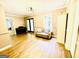 Open living room with wood floors and double doors with a piano at 2870 Willow Wisp Way, Cumming, GA 30040