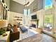 Stylish living room with soaring ceilings, brick fireplace, natural light and access to a deck for outdoor living at 2870 Willow Wisp Way, Cumming, GA 30040