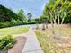 Sidewalk leads to community playground and basketball court surrounded by trees at 2870 Willow Wisp Way, Cumming, GA 30040