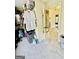 A carpeted walk-in closet with clothing racks, storage solutions and an open door to another room at 2870 Willow Wisp Way, Cumming, GA 30040