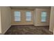Spacious bedroom featuring neutral walls, carpet, and three bright windows at 2867 Snapfinger Mnr, Decatur, GA 30035