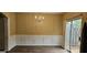 Dining room features chair railing, chandelier, wood-look flooring, and sliding glass door at 2867 Snapfinger Mnr, Decatur, GA 30035