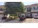 Exterior view of townhomes featuring brick accents, garages, and well-maintained landscaping at 2867 Snapfinger Mnr, Decatur, GA 30035