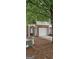 Brick townhome showcasing a garage, front door, and manicured landscaping at 2867 Snapfinger Mnr, Decatur, GA 30035