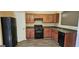 Kitchen featuring dark appliances, wood cabinets, and neutral paint at 2867 Snapfinger Mnr, Decatur, GA 30035