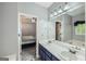 Bathroom boasts dual sinks, a big mirror and bathtub at 5640 Rolling Oaks Dr, Cumming, GA 30040
